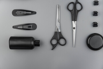 Professional hair dresser tools with copy space. Hair stylist equipment set on gray background....