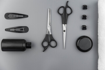 Professional hair dresser tools with copy space. Hair stylist equipment set on gray background....
