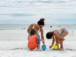 children and mom playing on the beach in Marco island by the JW marriott resort gulf of mexico stock photo royalty free 