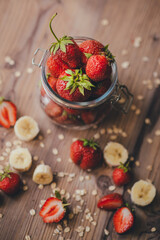 Strawberry with banana on wooden background