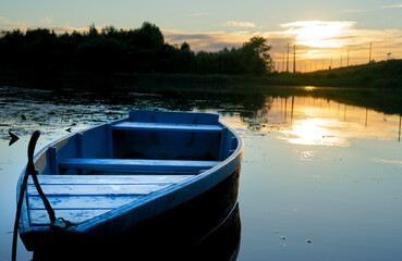 old wooden boats stand on the river in the evening