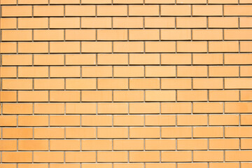 Brickwork background. New brick wall texture of orange color. Neat smooth brickwork.