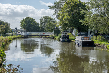 Fototapeta na wymiar Boats along the Leeds to Liverpool canal at Burscough