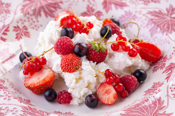 dessert with fresh berries on a red vintage plate. Farm cottage cheese