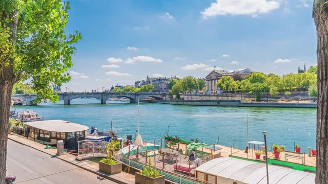 Timelapse of river Seine with fly boats passing by with motion blur ,zoom out from hitorical bridge and Notre-Dame de Paris is in sight.Sunny cloudy summer day paris famous riverside