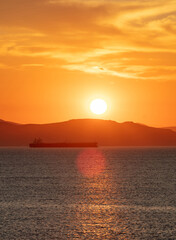 Sunrise, sunset clouds. Twilight, dusk cloudy sky over sea water, dark land horizon