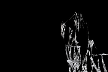 broken mirror glass on a black background in cracks in the form of an isolated image abstraction