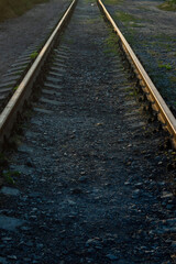 Obraz premium Railway rails in sunset. Railway in Ukraine. railway transport. Movement. Tourism. The concept of the way forward. Industrial background with the ability to apply a piece of text