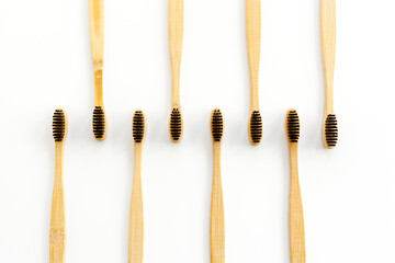 Eco materials concept with bamboo tooth brush on white background top view copy space