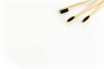 Eco materials concept with bamboo tooth brush on white background top view copy space