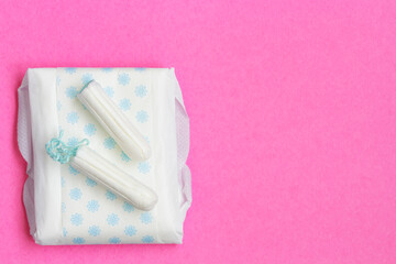 Women intimate hygiene products on pink background. Tampons and sanitary pads. monthlies period...