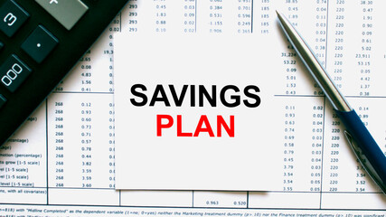 Naklejka na ściany i meble Work smarter text Savings Plan on white sheet with pen, calculator and tables