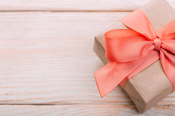 Beautiful gift box with altas bow on a vintage wooden board. holiday card concept.