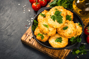 Chicken cutlet at dark table.