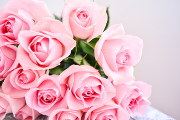 a bouquet of delicate pink roses on a light background