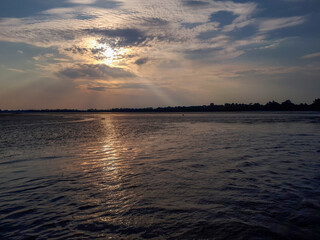 Scenic view of sunset over the sea in Grado, Italy. Waves in motion and reflections.