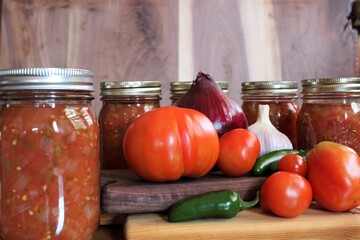 fresh tomatoes and jalapenos from a family farm vegetable garden with garlic and red onion for home...