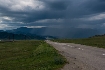 Fototapeta na wymiar a deserted road and a blue sky - an impending storm