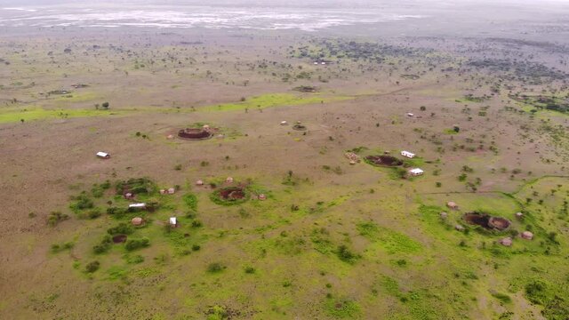 Aerial Flyby View on the Maasai village in on the coast of Natron Lake front of the Ol Doinyo Lengai, Mountain of God in the Maasai language, Engare Sero village in Arusha Region i the Northern