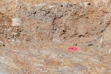 red marked measurement for a batter board in a hole