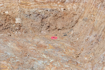 red marked measurement for a batter board in a hole