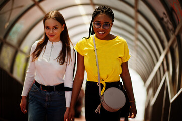 White caucasian girl and black African American together on tonnel. World unity, racial love,...