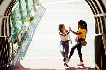 White caucasian girl and black African American together on tonnel. World unity, racial love, understanding in tolerance and races diversity cooperation.