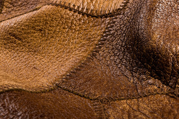 Old vintage genuine soft brown leather texture background, top layer with pores and scratches, macro, close-up