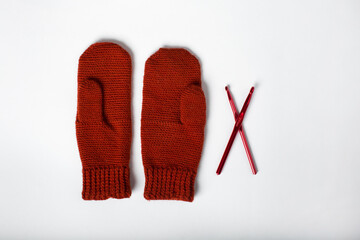 knitted gloves in red on a white background