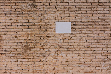 Wall of bricks and sign