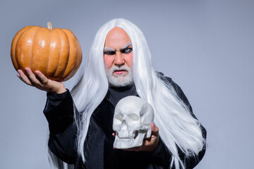 Halloween makeup. Horror. Halloween decoration. Scary concept. 31 october. Halloween man with pumpkin in skull. Devil man on Halloween pumpkin. Devil.
