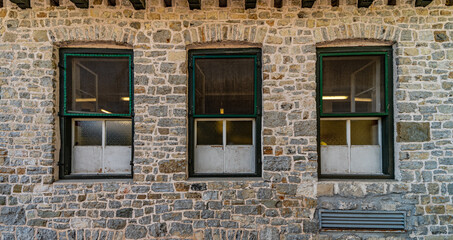 Fototapeta na wymiar Series of windows lined up on a building of clear stones