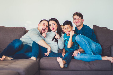 family watching tv together making faces 