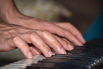 Fototapeta premium extreme closeup scene of a man playing piano, hands only.