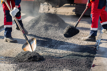 Repair of roads, highways and sidewalks. Patching. Working with a shovel falls asleep in the pit