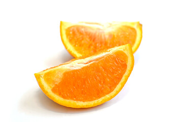 Two slices of orange on a white background
