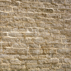 stone wall of roughly cut limestone blocks of different sizes as a background