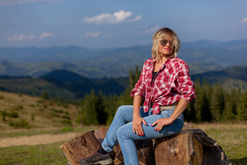 Naklejka na ściany i meble cute girl in denim clothes in the carpathian mountains