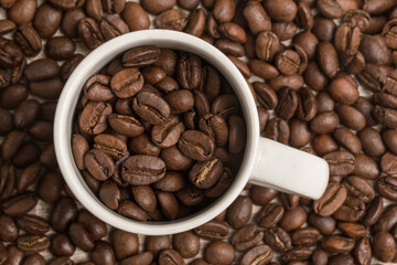 coffee beans inside and outside a cup, texture and color, studio close up