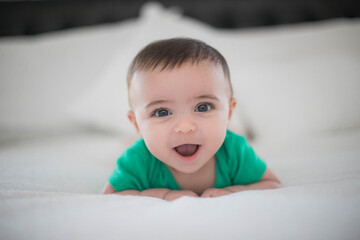Baby in bed playing 