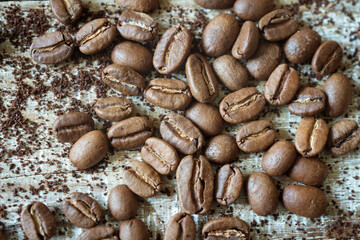 coffee beans are scattered on a wooden background
