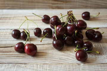 dark berries of ripe cherries on a wooden background