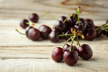 dark berries of ripe cherries on a wooden background