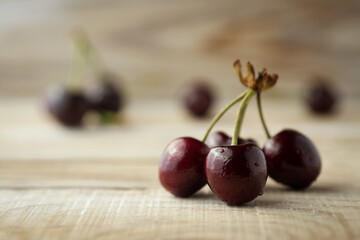dark berries of ripe cherries on a wooden background