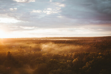 sunset on the horizon and haze over the forest