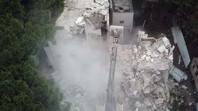  Urban Regeneration. Demolition of a building for new construction. Dismantling of a house. Excavator demolishing barracks for new construction project. Urban Renewal&lrm;.