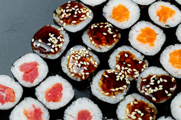 Japanese food. Rolls with ripe avocado, red fish, salmon, fresh rice with vegetables in nori. Set with rolls