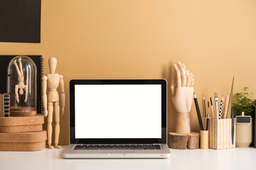 Laptop mockup at stylish workspace with wooden and cork accessories against brght brown wall..
