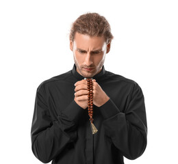 Handsome praying priest on white background