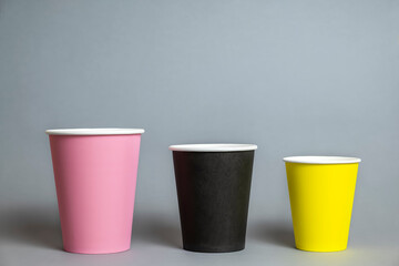 Paper cups on grey background. Text space